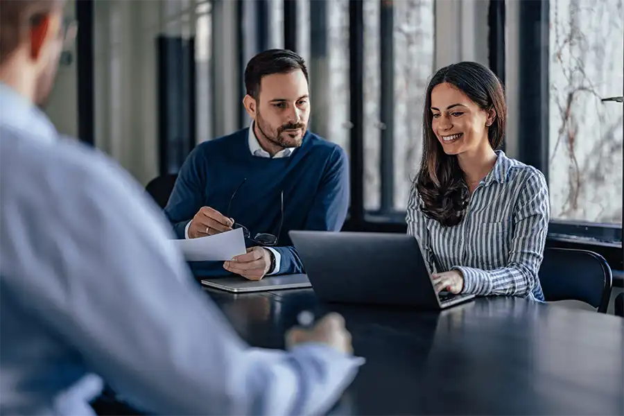 Understanding Impact, Driving Change Two business men in a meeting